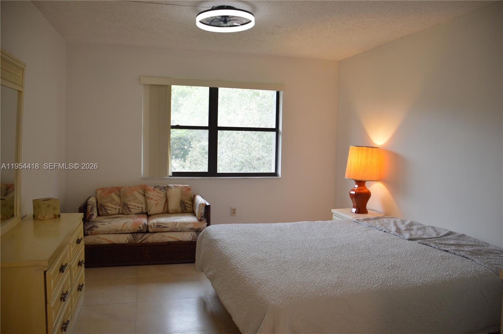 461 Ives Dairy Road, Unit 4042 Miami, FL 33179 - Photo 8 of 20 a bedroom with a bed couch and window