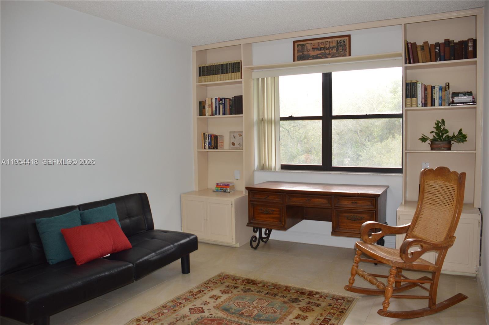 461 Ives Dairy Road, Unit 4042 Miami, FL 33179 - Photo 9 of 20 a living room with furniture and a window