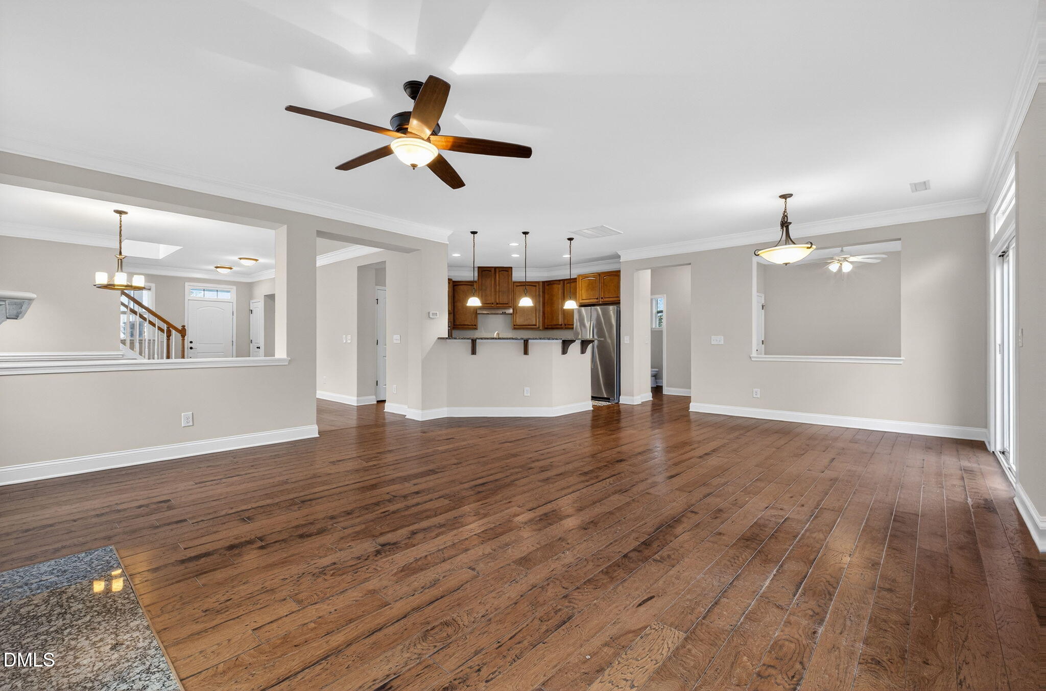 1304 Barnford Mill Road Wake Forest, NC 27587 - Photo 20 of 44 a view of a livingroom with a hardwood floor and a ceiling fan