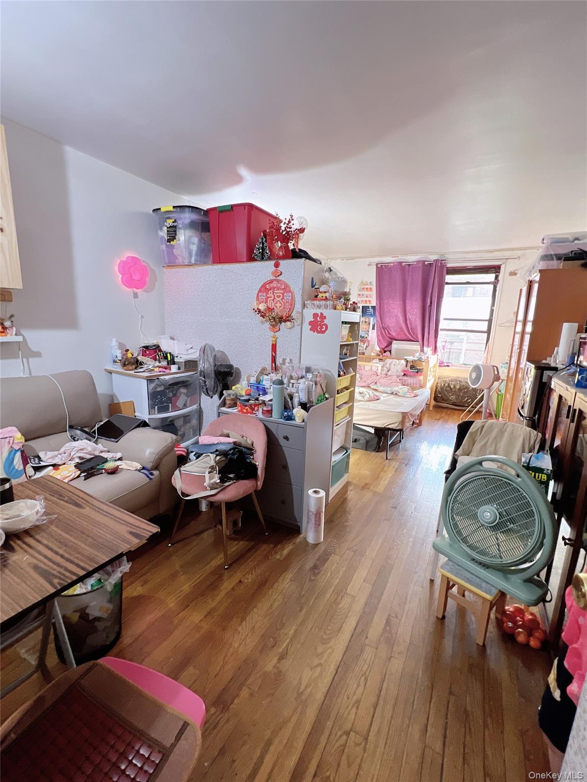 137-10 Franklin Avenue, Unit 415 Queens, NY 11355 - Photo 4 of 9 a living room with furniture and a wooden floor