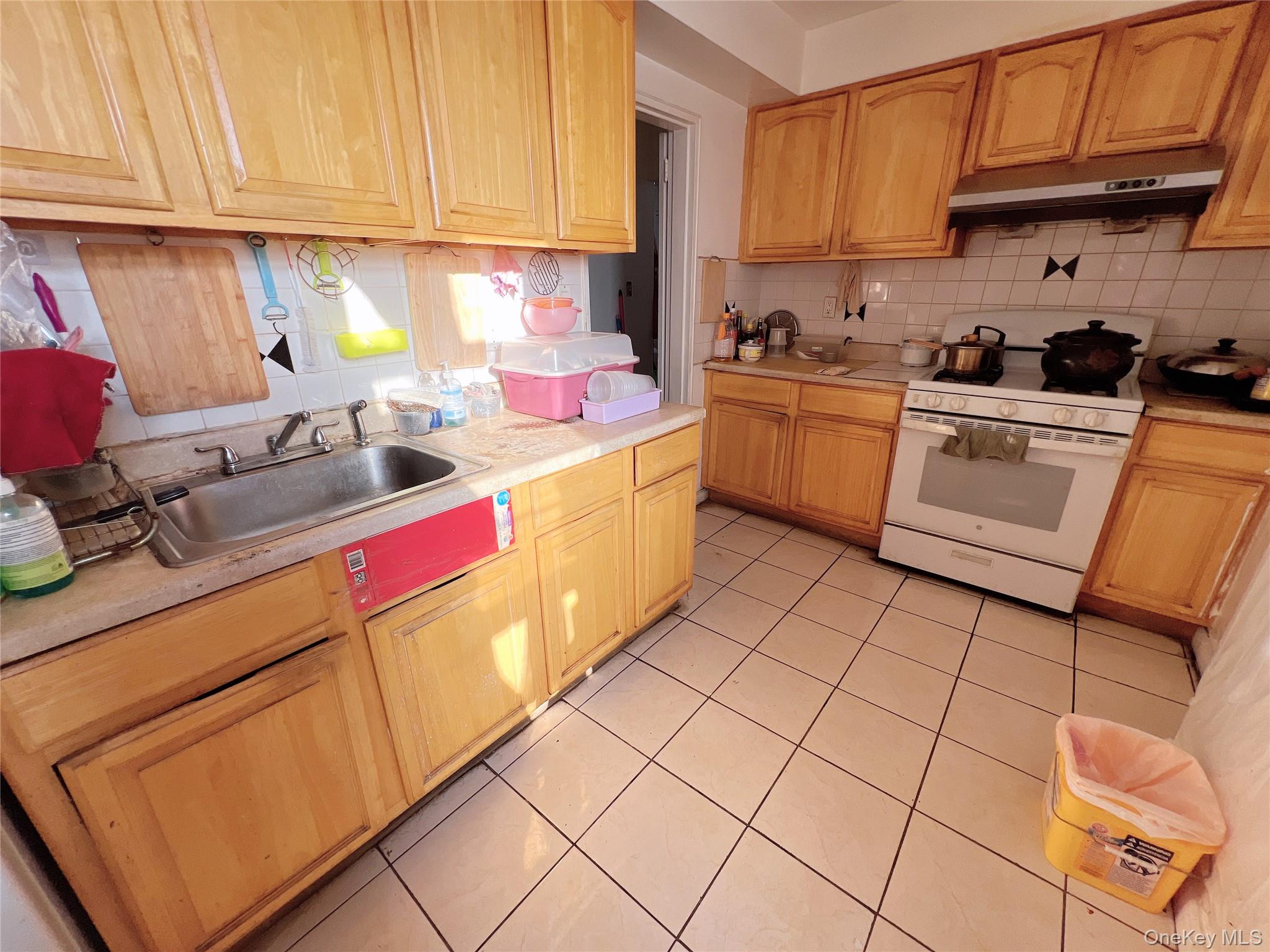 137-10 Franklin Avenue, Unit 415 Queens, NY 11355 - Photo 6 of 9 a kitchen with a sink and cabinets