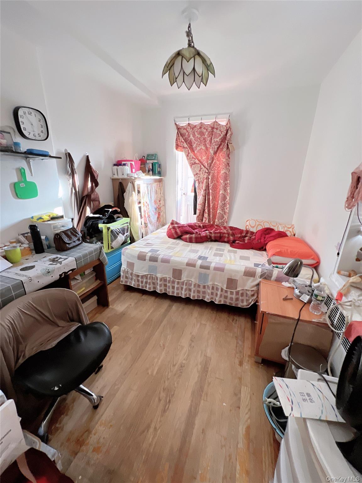 137-10 Franklin Avenue, Unit 415 Queens, NY 11355 - Photo 8 of 9 a bedroom with a bed and window