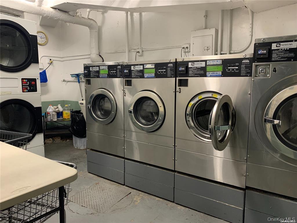 137-10 Franklin Avenue, Unit 415 Queens, NY 11355 - Photo 9 of 9 a utility room with dryer washer and a sink