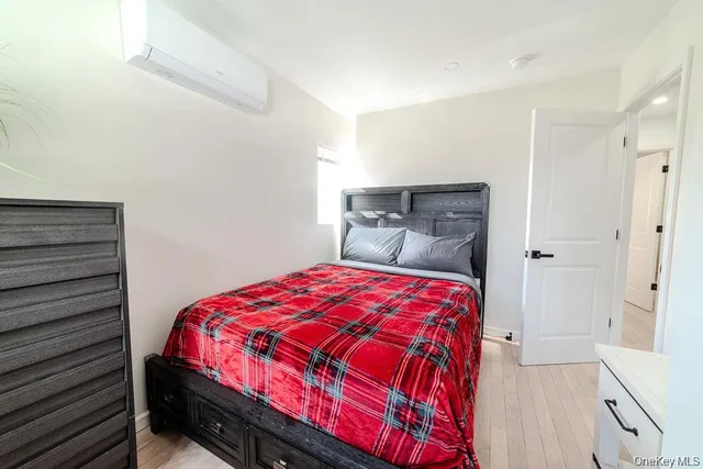 a bedroom with a bed and a mirror