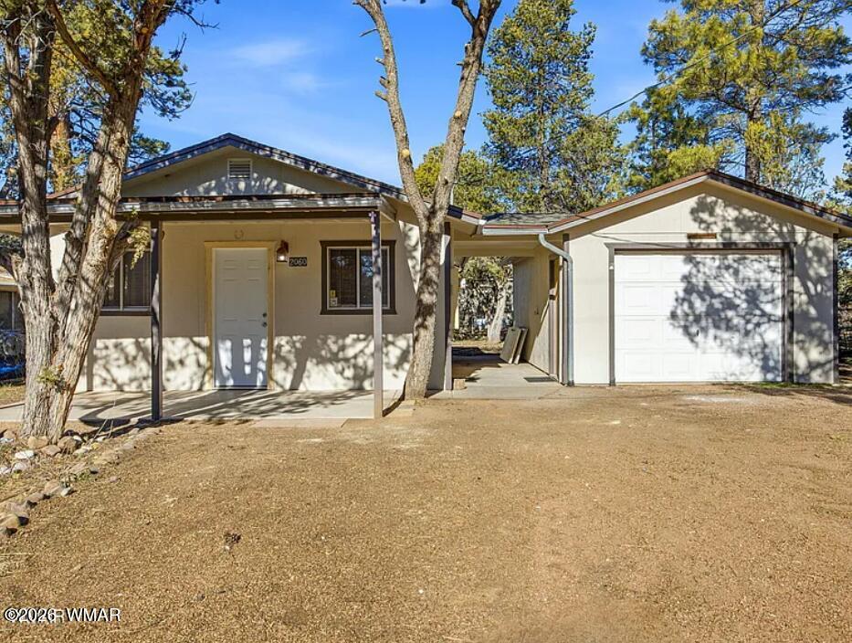 2060 Wilderness Drive Overgaard, AZ 85933 - Photo 1 of 3 a front view of a house with a yard
