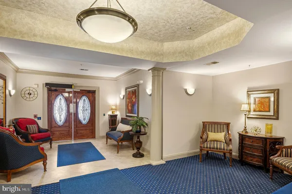 a living room with furniture and a chandelier