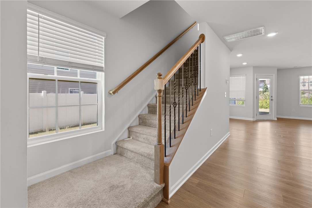 520 Brasstown Court Pendleton, SC 29670 - Photo 11 of 29 This interior highlights a harmonious blend of carpeted stairs and warm hardwood flooring.