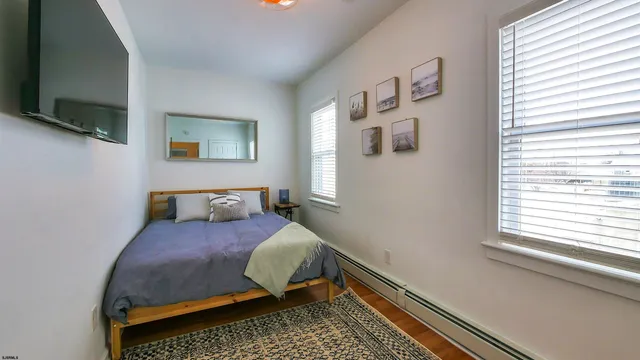 a bedroom with a bed and flat screen tv