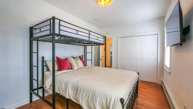 a bed sitting in a bedroom next to a window