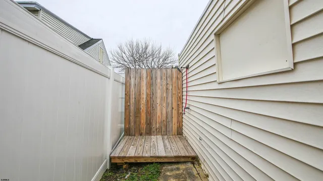 a small space with wooden floor and a window