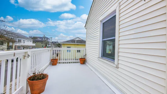 a balcony with water view of the house