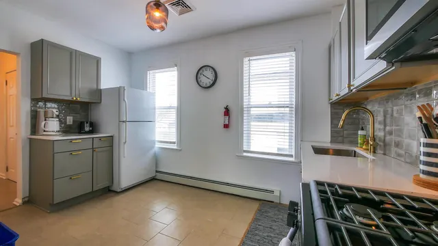 a kitchen with a refrigerator and windows