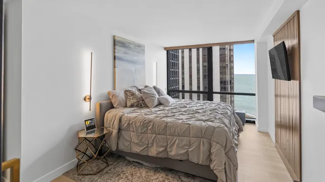 a bed sitting in a bedroom next to a window