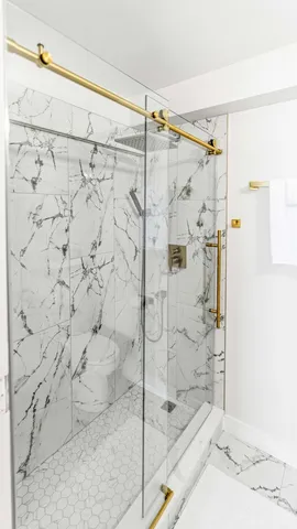 a bathroom with a shower and a sink