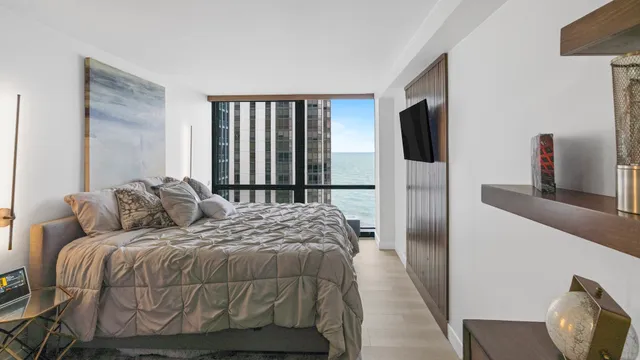 a bedroom with a bed and flat screen tv