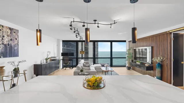 a living room with furniture a flat screen tv and a large window