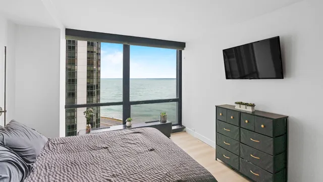 a bedroom with a bed and a television