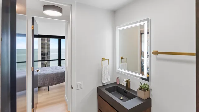 a view of bathroom with a mirror and a sink