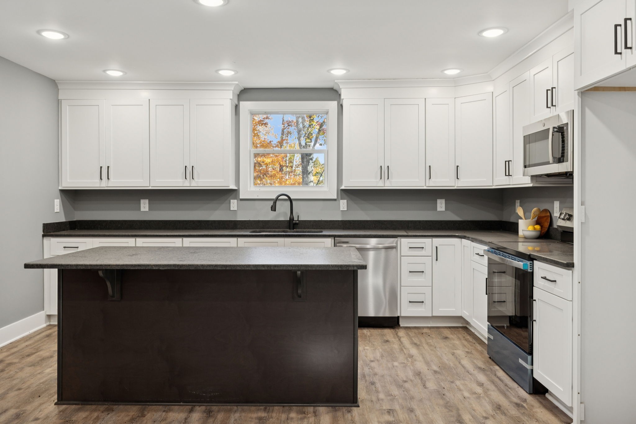 1529 Pea Ridge Road Liberty, TN 37095 - Photo 15 of 53 a kitchen with stainless steel appliances granite countertop a stove a sink and white cabinets