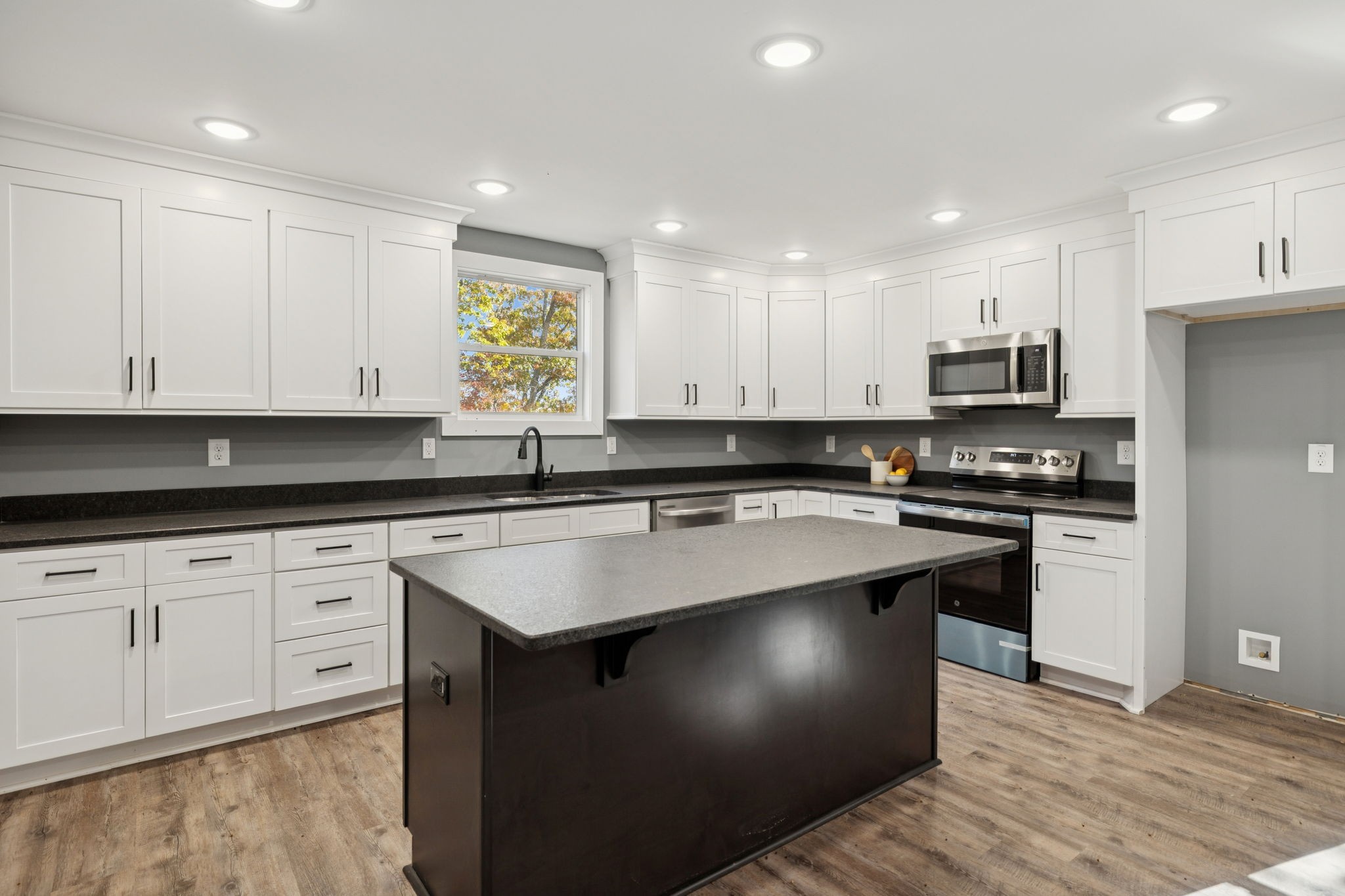 1529 Pea Ridge Road Liberty, TN 37095 - Photo 16 of 53 a kitchen with stainless steel appliances granite countertop a sink stove and refrigerator