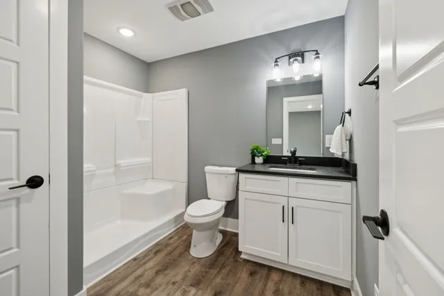 a view of an empty room with closet and a window