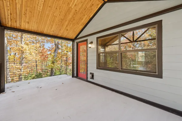 a view of a porch with wooden floor and windows