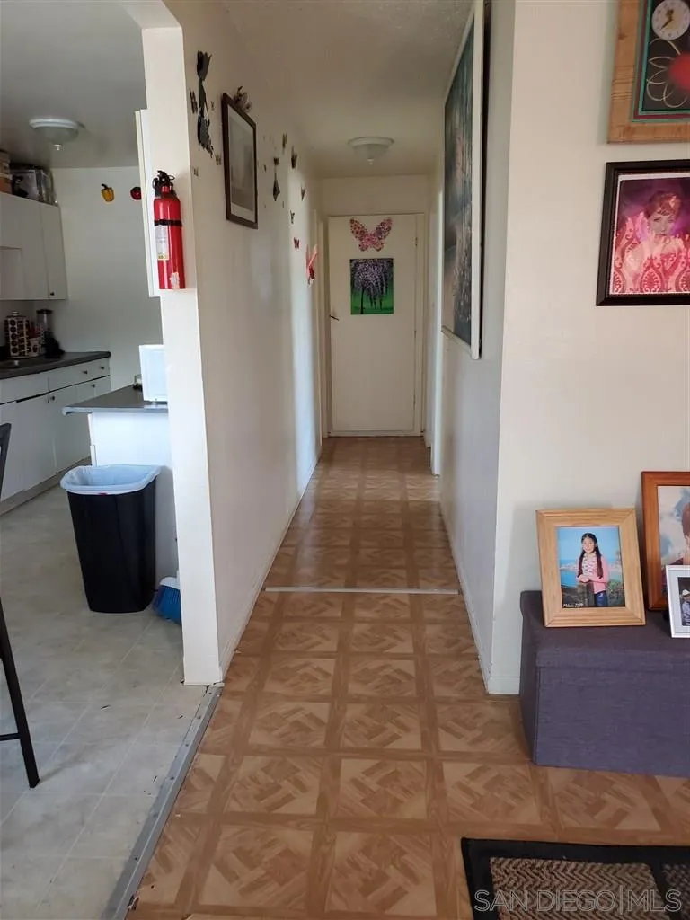 333 Lansing Circle Escondido, CA 92025 - Photo 12 of 18 a hallway with painting on the wall and a potted plant