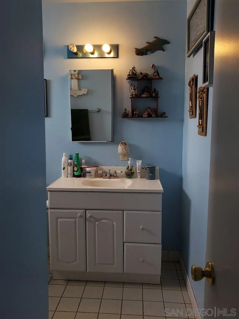 333 Lansing Circle Escondido, CA 92025 - Photo 14 of 18 a bathroom with a sink and a mirror