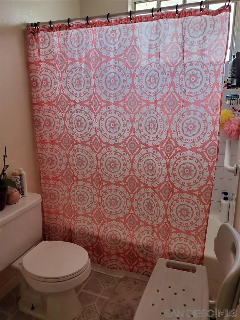 333 Lansing Circle Escondido, CA 92025 - Photo 15 of 18 a white toilet sitting next to a shower curtain