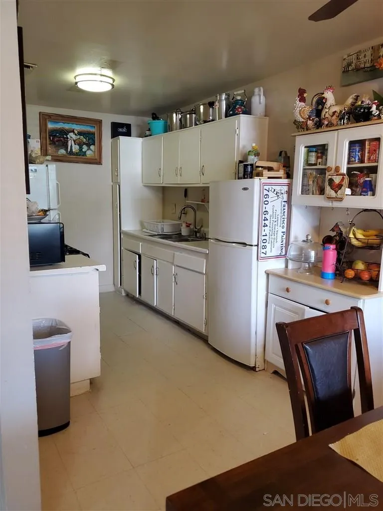 333 Lansing Circle Escondido, CA 92025 - Photo 5 of 18 a kitchen with stainless steel appliances a refrigerator sink and wooden floor