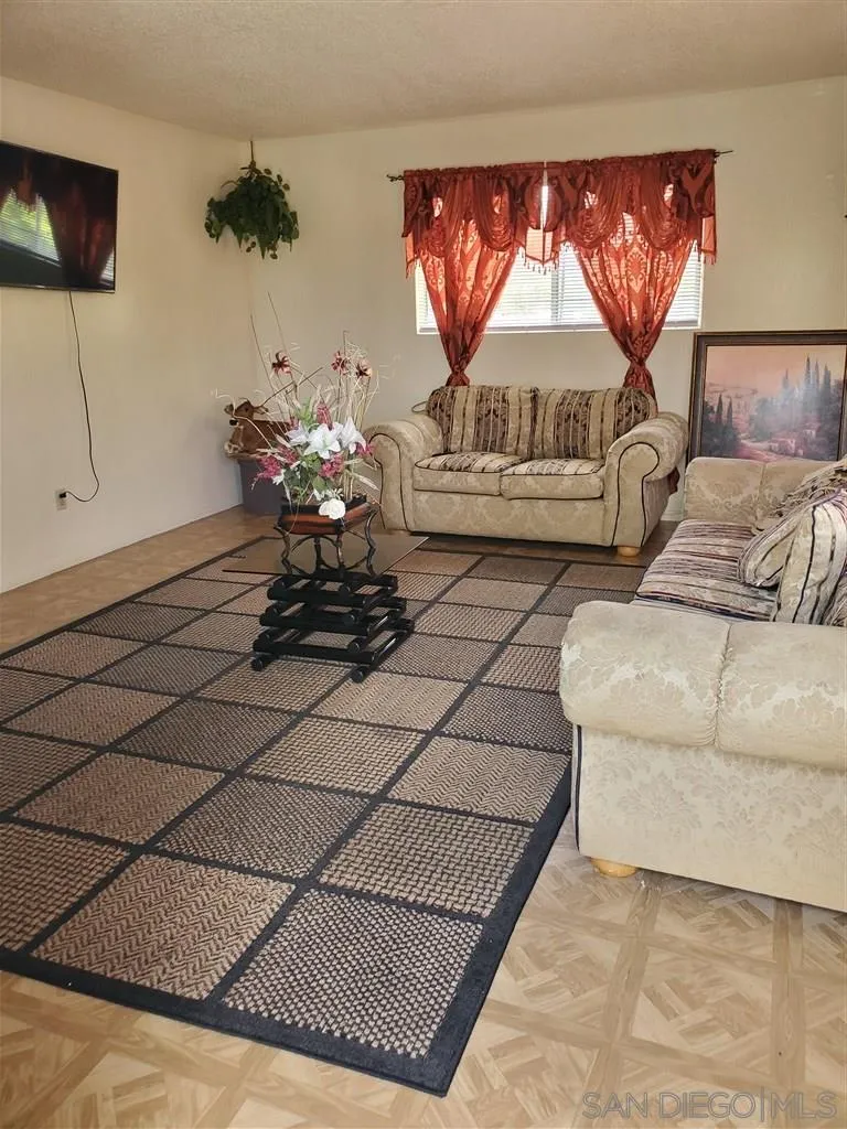 333 Lansing Circle Escondido, CA 92025 - Photo 10 of 18 a living room with a couch and a flat screen tv