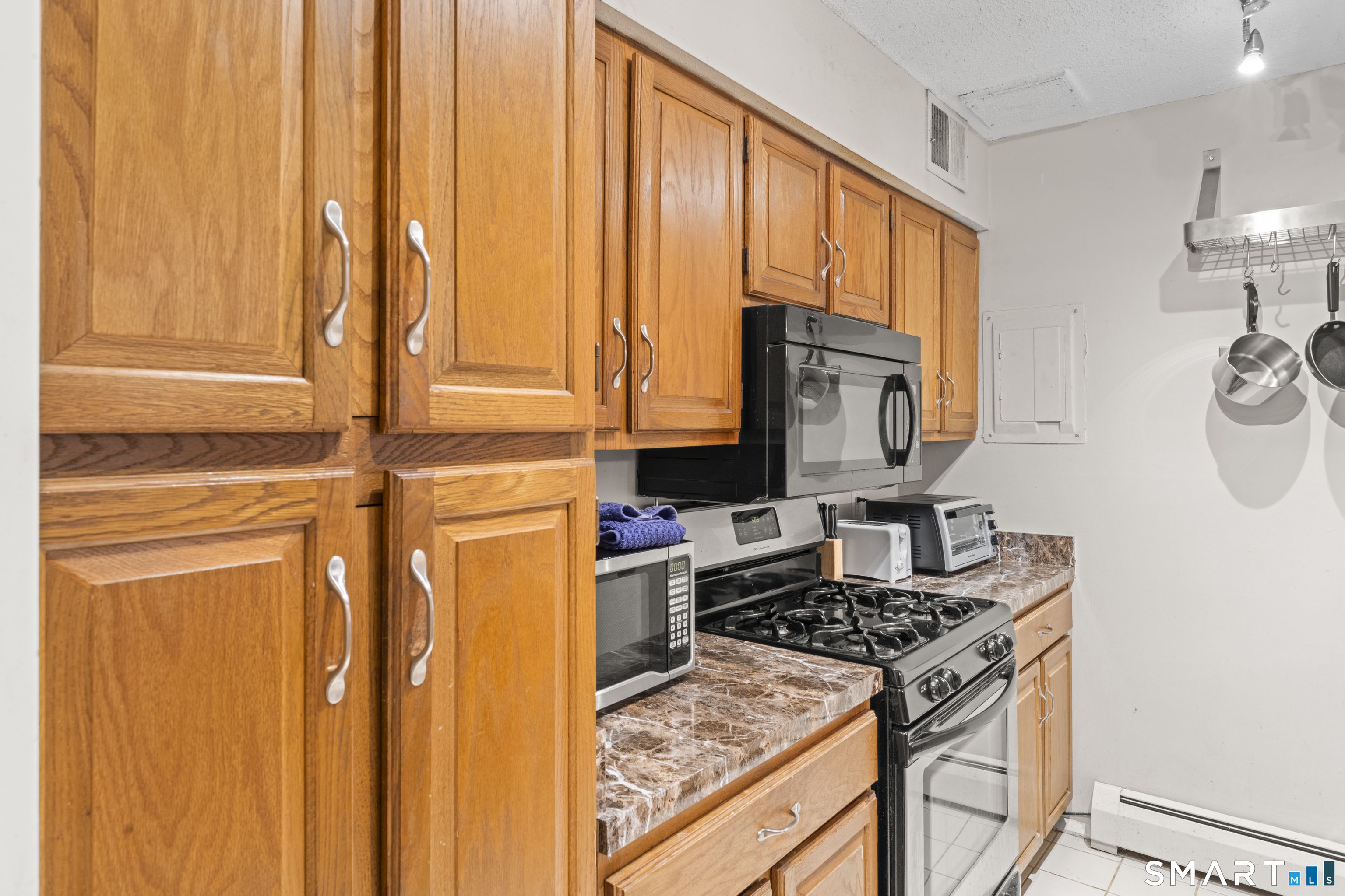 5 Talcott Ridge Road, Unit F Farmington, CT 06032 - Photo 5 of 31 Kitchen - Additional kitchen view showcasing ample cabinet storage, gas range, and efficient workspace.