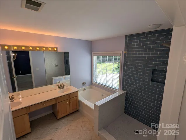 a room with a bed and large mirror