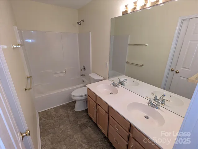 a spacious bathroom with a double vanity sink mirror double and a bathtub