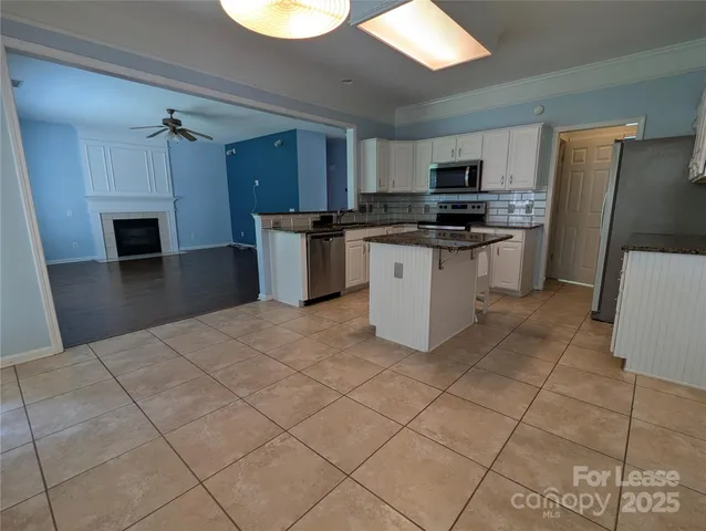 a kitchen with stainless steel appliances a refrigerator sink and microwave