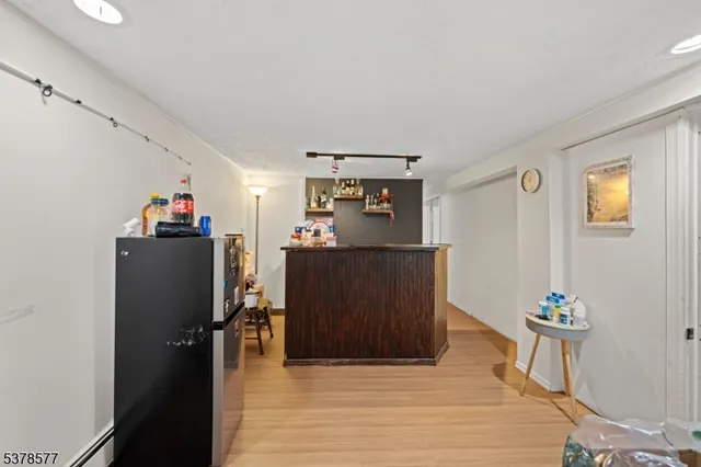 a bedroom with a bed and a view of kitchen