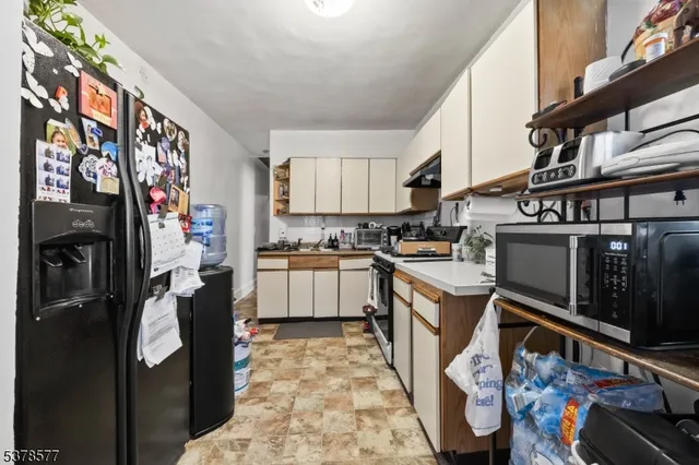 a kitchen with stainless steel appliances granite countertop a sink and cabinets
