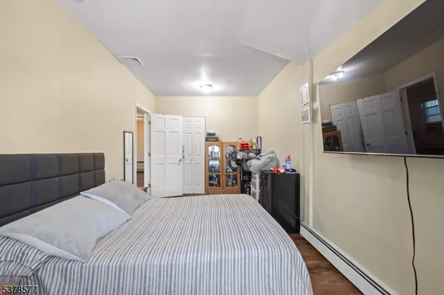 a bed room with a bed and a television