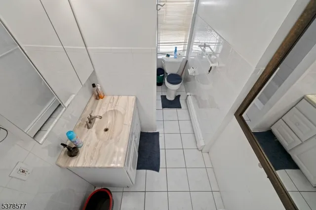 a bathroom with a sink toilet a mirror and shower