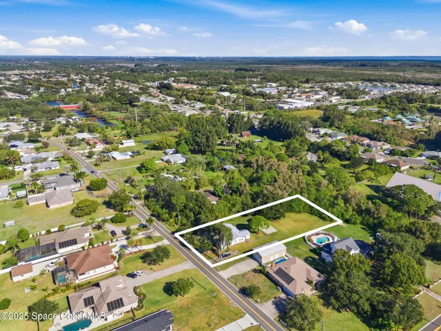an aerial view of a house with a ocean view