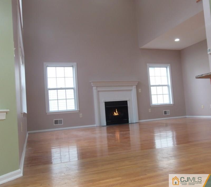 67 Shaffer Road Bridgewater, NJ 08807 - Photo 14 of 25 an empty room with wooden floor and fireplace