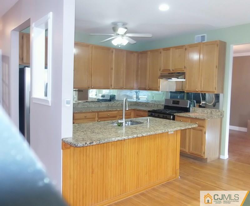 67 Shaffer Road Bridgewater, NJ 08807 - Photo 18 of 25 a kitchen with stainless steel appliances granite countertop a sink refrigerator and cabinets