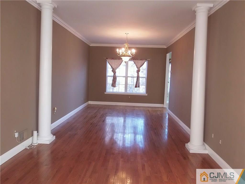 67 Shaffer Road Bridgewater, NJ 08807 - Photo 4 of 25 an empty room with wooden floor and windows