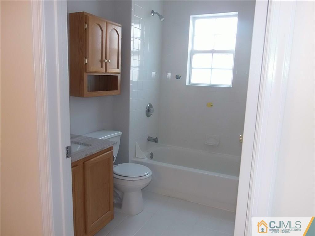 67 Shaffer Road Bridgewater, NJ 08807 - Photo 8 of 25 a bathroom with a granite countertop toilet a sink and bathtub