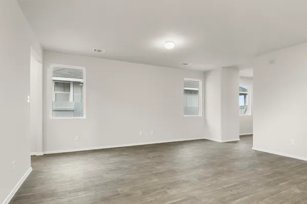 a open kitchen with stainless steel appliances kitchen island a sink dishwasher a refrigerator and white cabinets with wooden floor