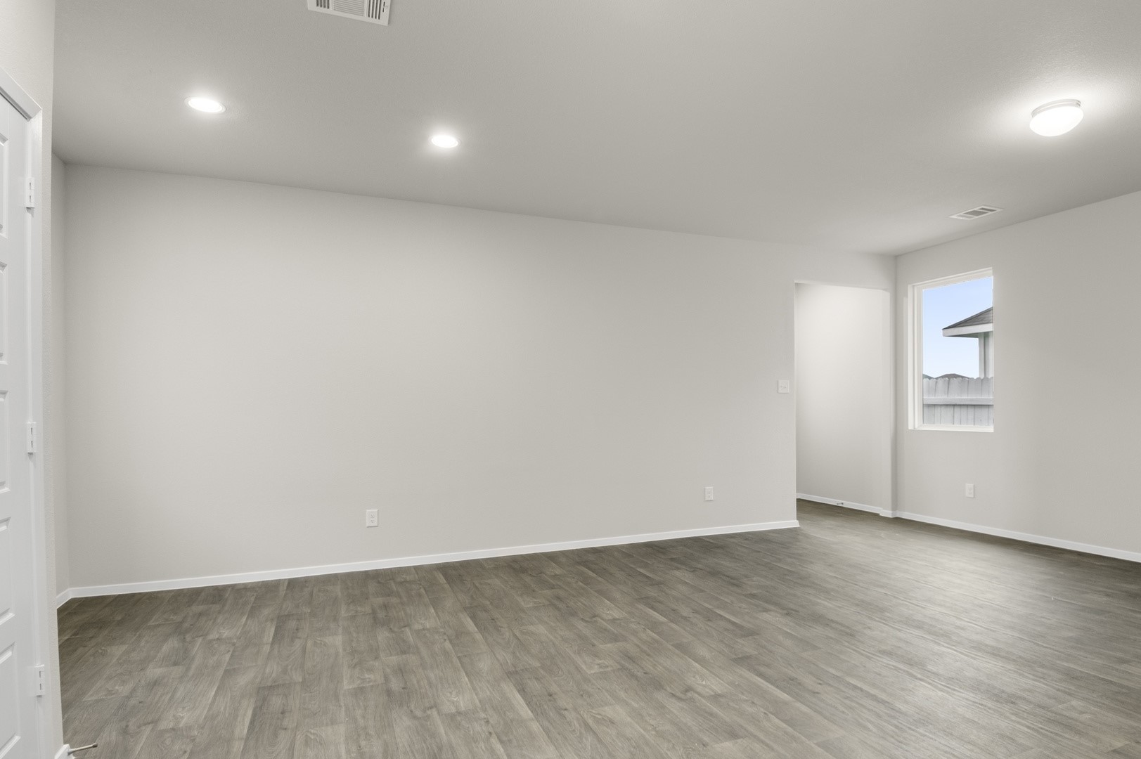 3043 Winding Creek Road Kyle, TX 78640 - Photo 15 of 30 an empty room with wooden floor & window and bathroom