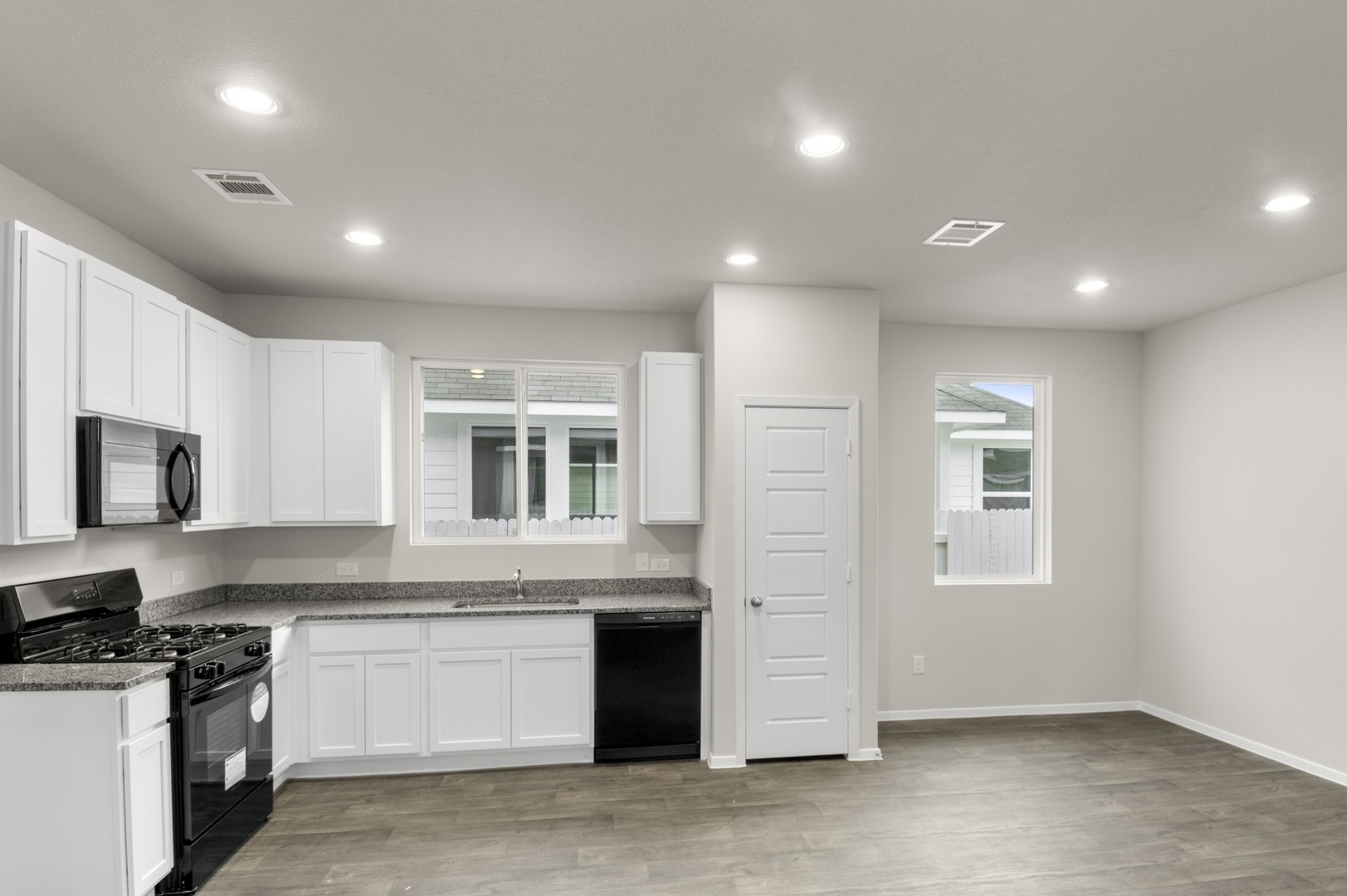 3043 Winding Creek Road Kyle, TX 78640 - Photo 17 of 30 a kitchen with stainless steel appliances granite countertop a stove a sink and a microwave