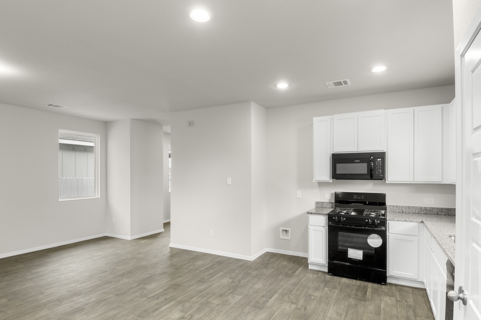3043 Winding Creek Road Kyle, TX 78640 - Photo 20 of 30 a kitchen with a refrigerator and a stove top oven