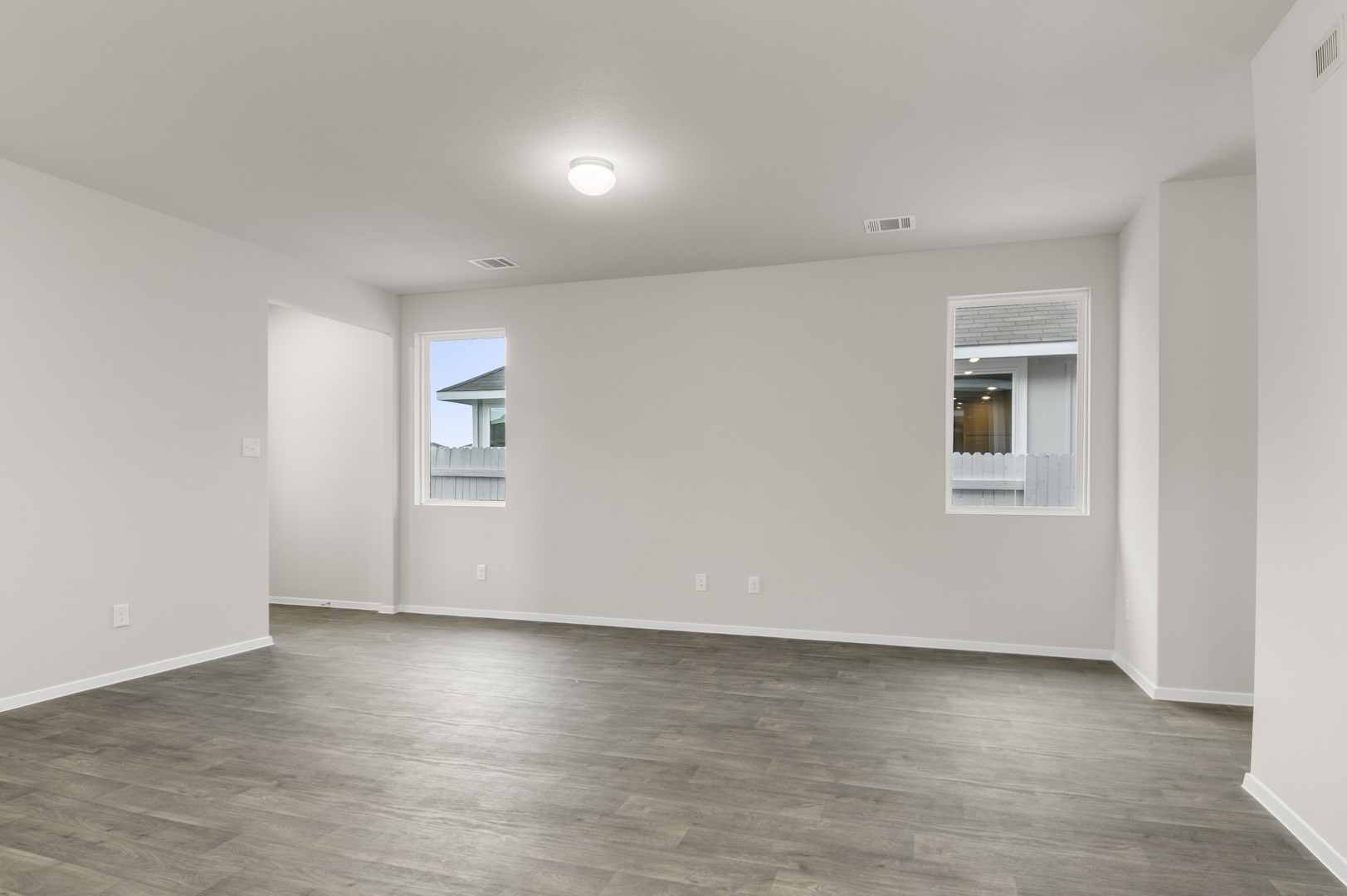 3043 Winding Creek Road Kyle, TX 78640 - Photo 6 of 30 a view of an empty room with wooden floor and a window