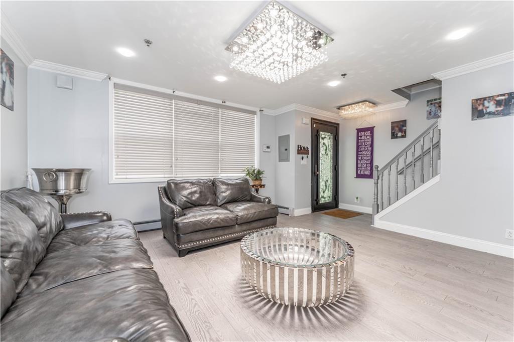 724 Egan Street Brooklyn, NY 11239 - Photo 5 of 10 a living room with furniture and a chandelier